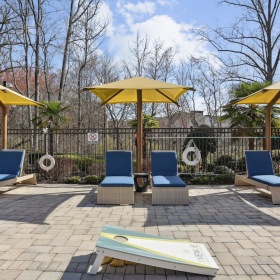 Relax and unwind poolside lounge chairs and umbrellas by a pool