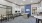 a room with tables, chairs and computer workstations